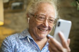 Senior woman smiling in video call in the new normal